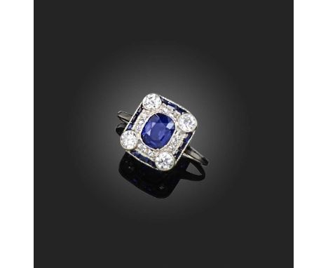 An Art Deco sapphire and diamond ring, set with a cushion-cut sapphire and four circular-cut diamonds, within a rounded squar