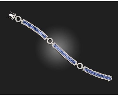 A sapphire and diamond bracelet, composed of three elongated articulated sections of linking, set with calibré-cut sapphires 