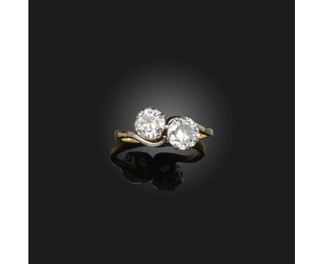 A diamond ring, early 20th century, of toi-et-moi design, set with two circular-cut diamonds totalling approximately 1.30 car