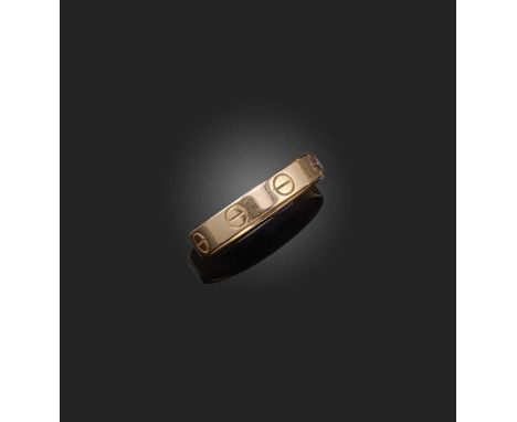 Cartier, a gold 'Love' ring, designed as a manacle decorated with screw motifs, in 18ct rose gold, size L, signed Cartier, nu