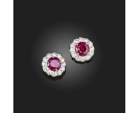 A pair of ruby and diamond earrings, each of cluster design, set with a circular-cut ruby within a border of brilliant-cut di