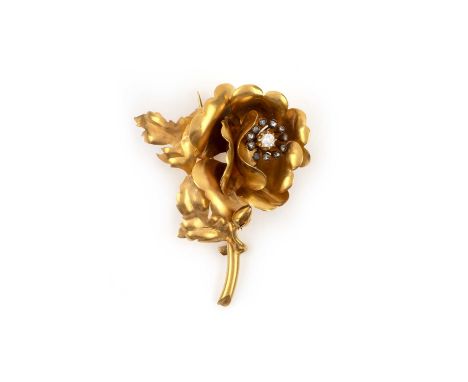 A gold and diamond brooch, late 19th century, designed as a rose modelled in gold, set with a cushion-shaped diamond within a