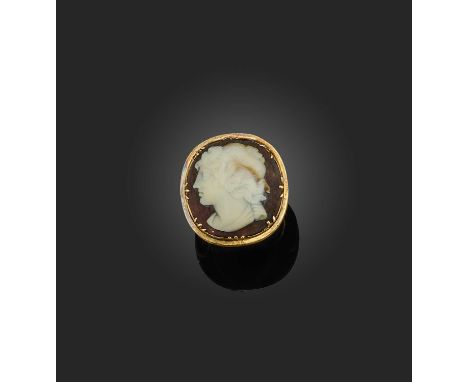 A shell cameo ring, early 19th century, set with a shell cameo depicting a classical woman in profile, in a gold collet-setti