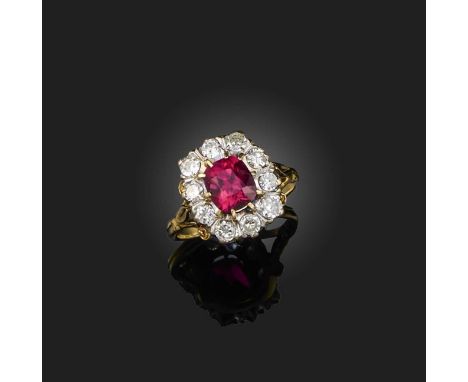 A synthetic ruby and diamond ring, of cluster design, set with a cushion-shaped ruby within a border of brilliant-cut diamond