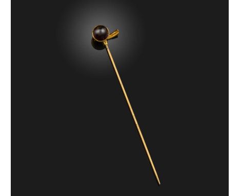 A garnet and gold stick pin, Russia, late 19th century, designed as an acorn, set with a cabochon garnet, mounted in gold, th