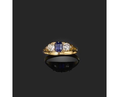 A late 19th century sapphire and diamond ring, set with a cushion-cut sapphire between two old-cut diamonds, mounted in a car