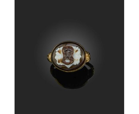 An onyx cameo ring, 19th century, set with an oval onyx cameo depicting a tragic Greek theatre mask over the double-faced god