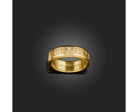 Tiffany &amp; Co., a gold ring, 'Atlas', circa 2003, the gold band centring on a sequence of Roman numerals, size Q, signed T