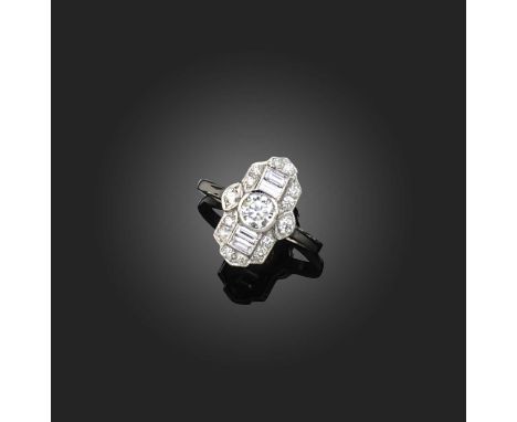 A diamond ring, of geometric design, centring on a brilliant-cut diamond, framed by baguette-cut and single-cut diamonds, all