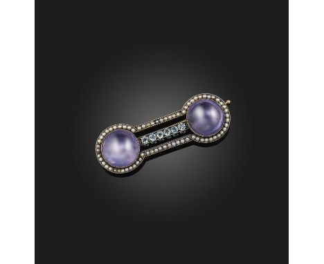 August Hollming for Fabergé, a sapphire and seed pearl brooch, early 20th century, set with two cabochon purple sapphires, on