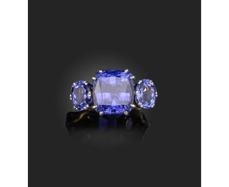 A tanzanite ring, set with a cushion-shaped tanzanite between shoulders set with oval tanzanites, mounted in 18ct gold, size 