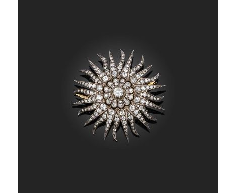 A late Victorian diamond starburst brooch, set with graduated old cushion-shaped diamonds in silver and gold, diameter 5cm, c