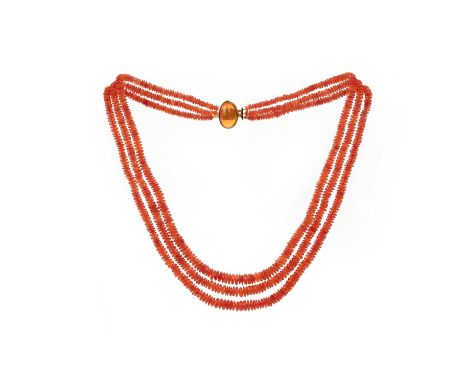 A fire opal necklace, composed of three strands of fire opal beads, to a clasp set with a cabochon fire opal, mounted in gold