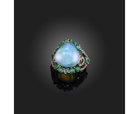 An opal, emerald and diamond ring, claw-set with a pear-shaped cabochon opal weighing 8.16 carats, to a surround of pear-shap