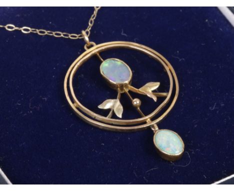 An Edwardian 9ct gold openwork opal pendant on later trace chain.