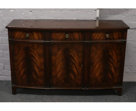 A rackstraw flame mahogany bow front sideboard raised on bracket feet.