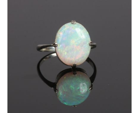 A vintage white metal ring claw set with a large ovoid opal, size K1/2. (Stone 1.2cm x 1cm, Depth 5mm)Condition report intend