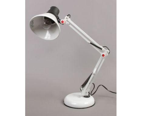 A white anglepoise table lamp.