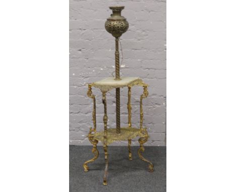 An Edwardian gilt metal and onyx two tier occasional table incorporating a rise and fall oil lamp.
