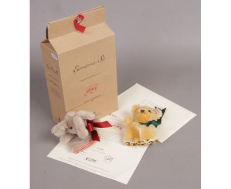 A boxed Steiff club edition egg cosy set, bear and elephant with tags and certificate.