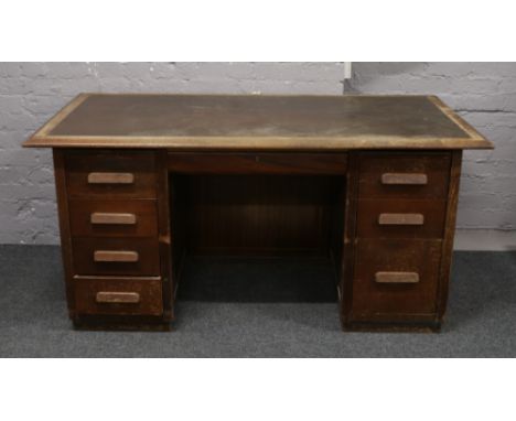 A 1930s office desk with inlaid leather top.