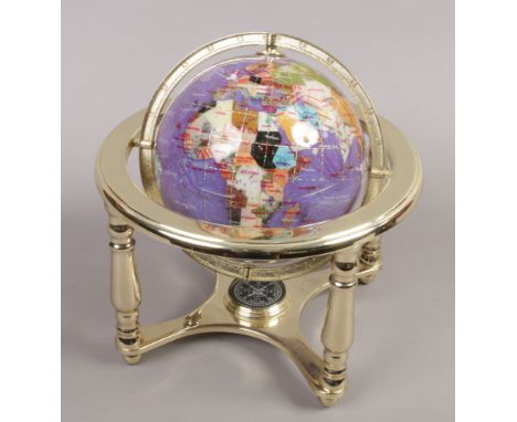 A small desktop gimbal globe on stand with compass and set with specimen hardstones.