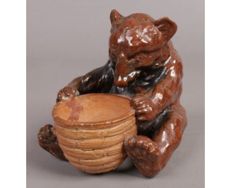 A Royal Doulton stoneware cruet formed as a bear with basket.Condition report intended as a guide only.Both rear legs re-glue