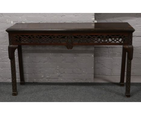 A Chippendale style mahogany serving table with pierced frieze and blind fret carved square supports, width 160cm x depth 47c