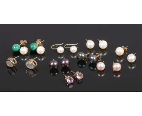 Nine pairs of earrings all with gold backs, eight pairs in 9ct gold and an 18ct gold example including coloured stone set and