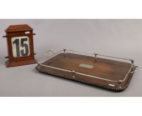 A mahogany cased vintage perpetual desk calendar along with an oak serving tray with white metal gallery.Condition report int
