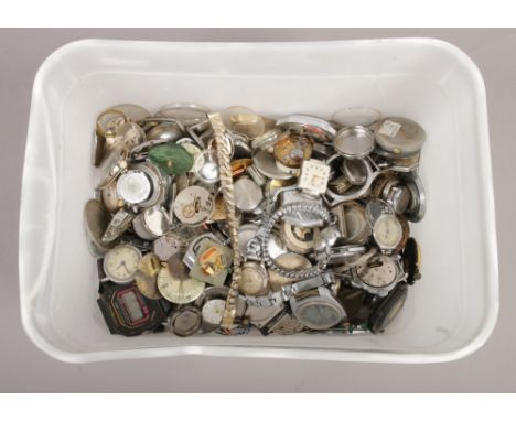 A box of watch movements, dials and glasses including Timex, Everite, Avia, Timex, Roamer etc.