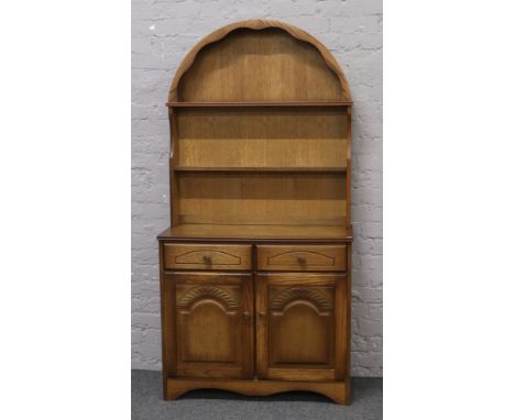 A light oak dome top dresser of slender proportions, Height 180cm x Width 92cm x Depth 40cm.
