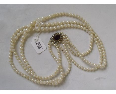 Tripe row of pearls with a 9ct amethyst and pearl clasp  