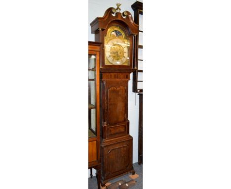 A George III oak and mahogany eight-day longcase clock, with brass arch top dial, silvered chapter ring, moon roller and two 