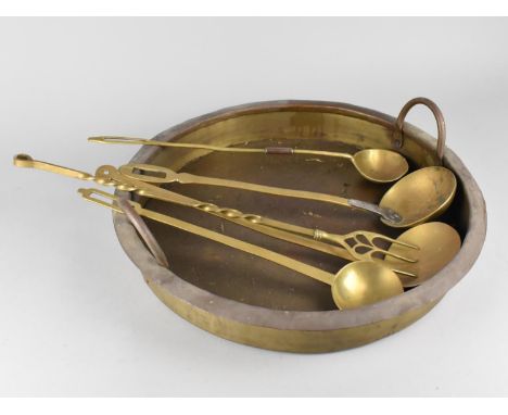 A Large Shallow Circular Two Handled Cooking Pot together with Various Brass Ladles and Toasting Fork, 45cms Diameter 