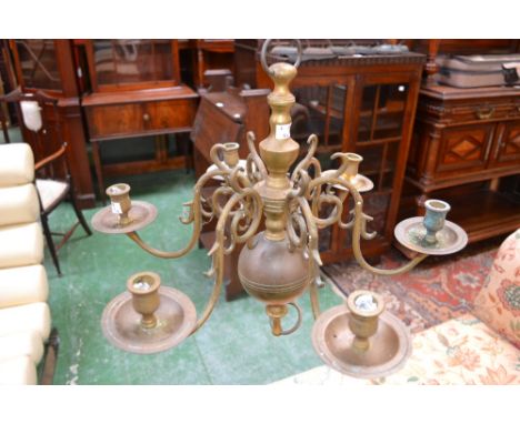 A William and Mary design brass six-light chandelier, the sections numbered, reel shaped sconces, broad drip pans, early 20th