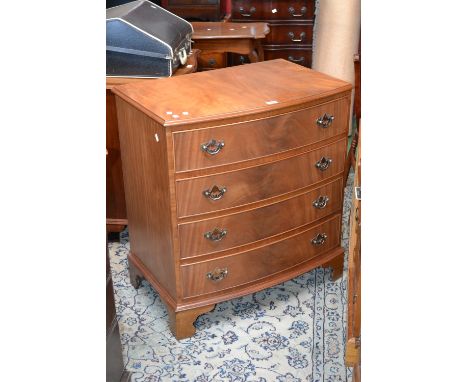 A reproduction mahogany serpentine front chest of drawers, four graduated drawers, bracket feet