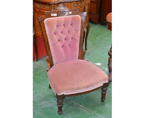 A Victorian mahogany nursing chair, cresting top rail, padded button back, stuffed overseat, turned and fluted forelegs.