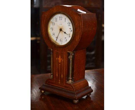 An Art Nouveau mahogany and inlaid mantel clock