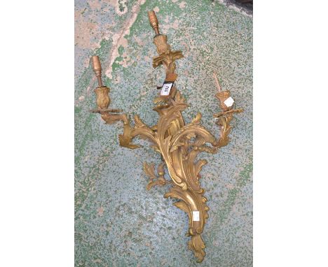 A gilt wall light with three branches 