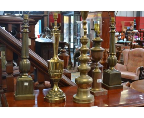 A pair of gilt metal table lamp stands, fluted columns above square fluted socles, 78cm high;  another, singular, baluster sh