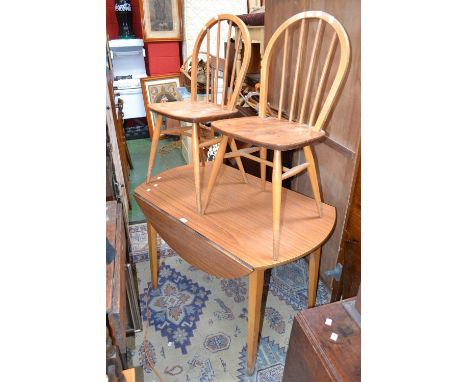 A melamine dropleaf table; two Ercol spindle back dining chairs (3)