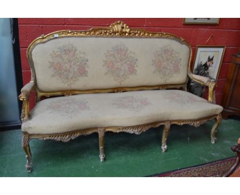 A French giltwood three seat sofa, shaped cresting top rail, padded back, outsweot open arms, serpentine stuffed overseat, Fr