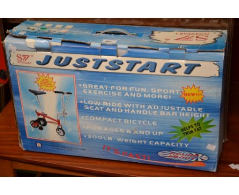 A Justart S7 compact bicycle for ages 8 and up, 300lb weight capacity, boxed