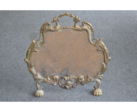 A cast metal mesh fire screen, with dragon motifs, paw feet, 62 cm high