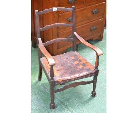 A Victorian oak child's ladder back chair, interwoven leather seat, turned forelegs