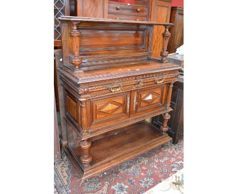 A mahogany tridarn single shelf to top supported by turned and fluted supports, two carved short drawers over block fronted c