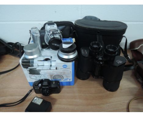 A Minolta Dimage Z1 camera (boxed, a Pentax auto 110 and flash and a pair of Prinz binoculars