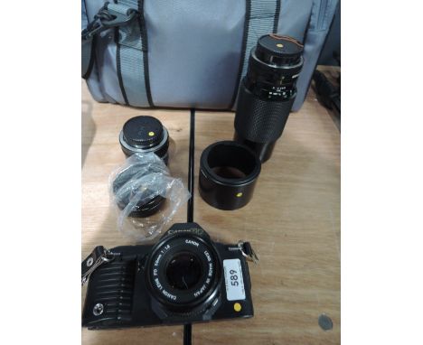 A Canon T70 camera with 50mm lens, Sigma super wide lens etc in soft  camera bag