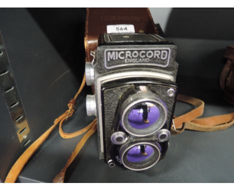 A Microcord twin lens reflex, 2-1/4 inch (6cm x 6cm) camera with Ross 77.5mm F3.2 lens, in original leather case.